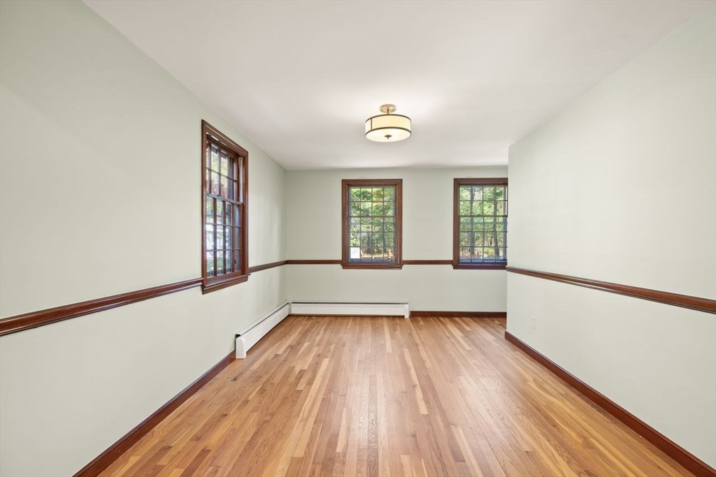 2 Briggs Pond Way Sharon, MA 02067 - Photo 11 of 42 a view of an empty room with wooden floor and a window