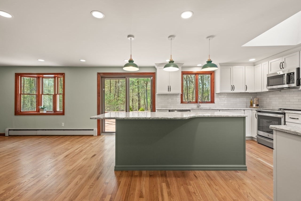 2 Briggs Pond Way Sharon, MA 02067 - Photo 13 of 42 a kitchen with stainless steel appliances granite countertop a stove a sink and a large window