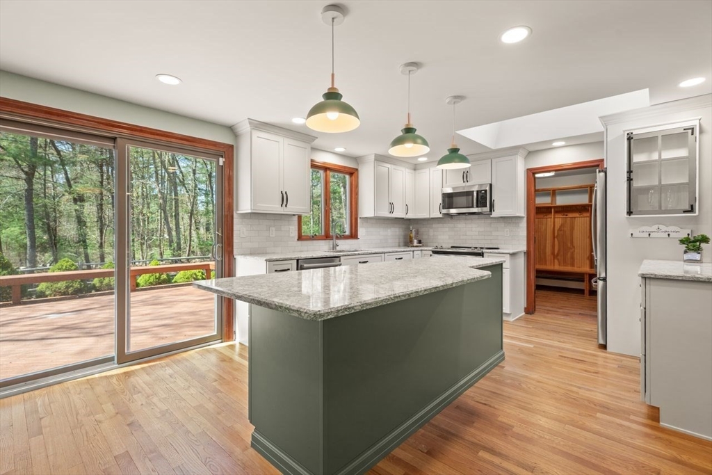 2 Briggs Pond Way Sharon, MA 02067 - Photo 14 of 42 a large kitchen with kitchen island a large counter top and stainless steel appliances