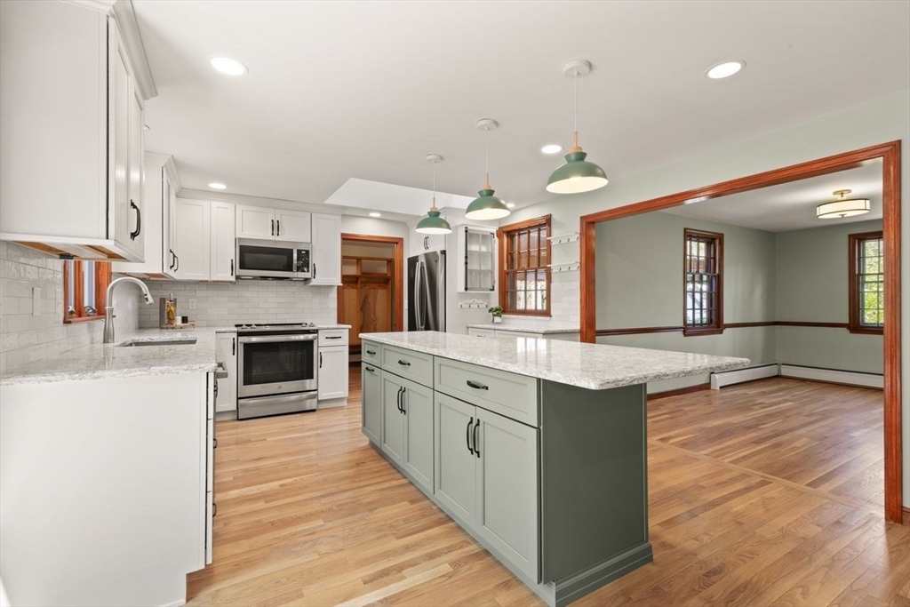 2 Briggs Pond Way Sharon, MA 02067 - Photo 15 of 42 a large kitchen with stainless steel appliances granite countertop a stove and cabinets
