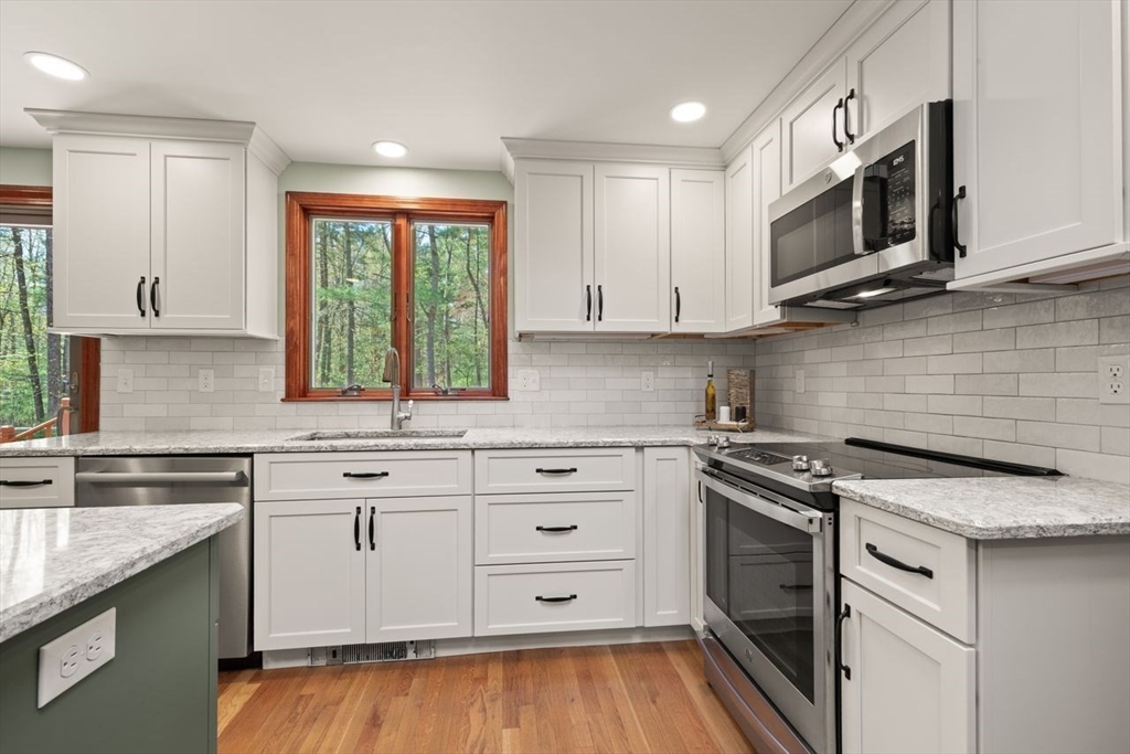 2 Briggs Pond Way Sharon, MA 02067 - Photo 17 of 42 a kitchen with stainless steel appliances granite countertop a stove and a microwave