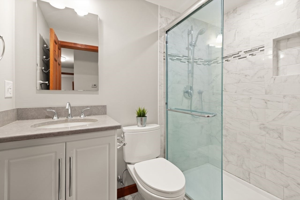 2 Briggs Pond Way Sharon, MA 02067 - Photo 27 of 42 a bathroom with a granite countertop sink toilet a mirror and shower