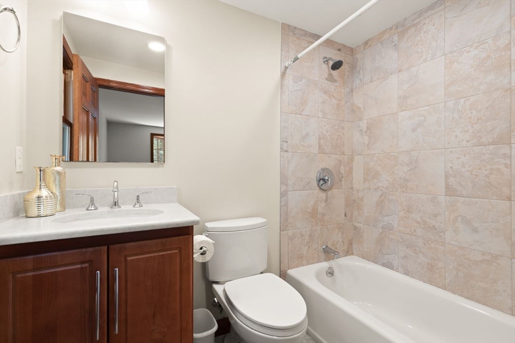 2 Briggs Pond Way Sharon, MA 02067 - Photo 31 of 42 a bathroom with a toilet a sink a mirror a bathtub and shower