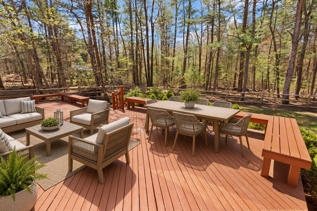 2 Briggs Pond Way Sharon, MA 02067 - Photo 34 of 42 a view of a patio with table and chairs and couches with wooden floor and fence