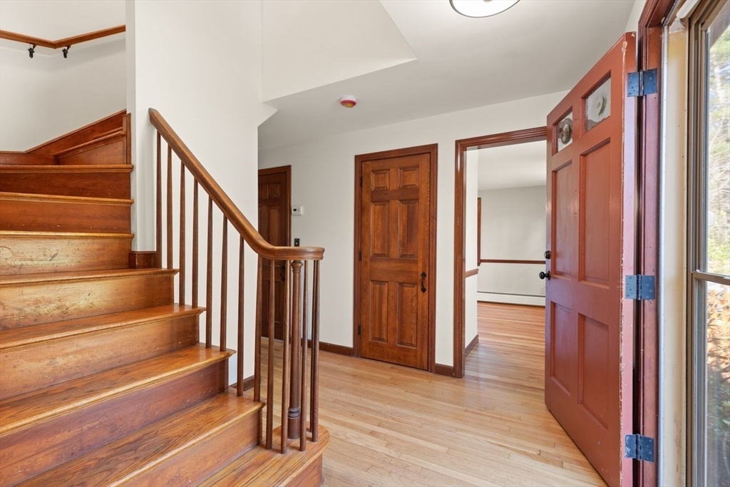 2 Briggs Pond Way Sharon, MA 02067 - Photo 5 of 42 a view of a hallway with wooden floor and staircase