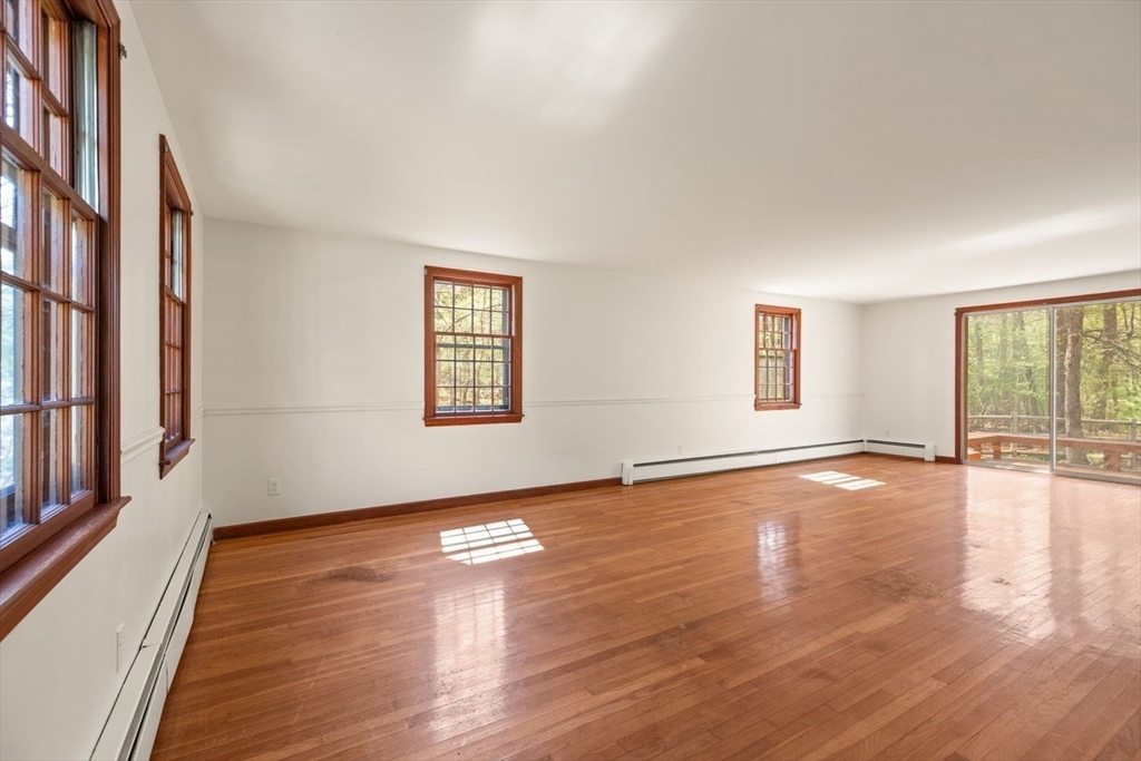 2 Briggs Pond Way Sharon, MA 02067 - Photo 7 of 42 a view of an empty room with wooden floor and a window