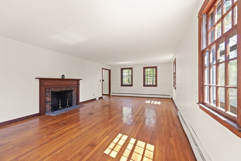 2 Briggs Pond Way Sharon, MA 02067 - Photo 8 of 42 wooden floor in an empty room with a fireplace