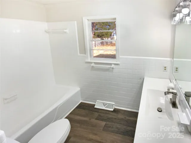 a bathroom with a sink a toilet and tub