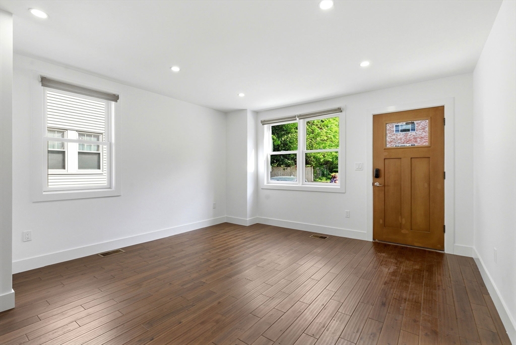 123 Nottinghill Road, Unit 2 Boston, MA 02135 - Photo 2 of 30 a view of an empty room with wooden floor and a window