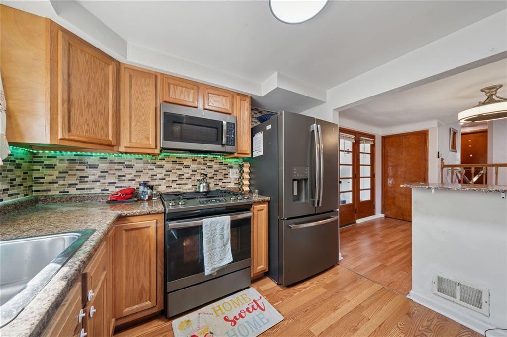 1202 Old Concord Road Monroeville, PA 15146 - Photo 11 of 27 a kitchen with stainless steel appliances granite countertop a refrigerator stove and sink