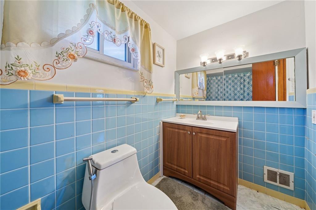 1202 Old Concord Road Monroeville, PA 15146 - Photo 18 of 27 a bathroom with a sink a toilet and mirror