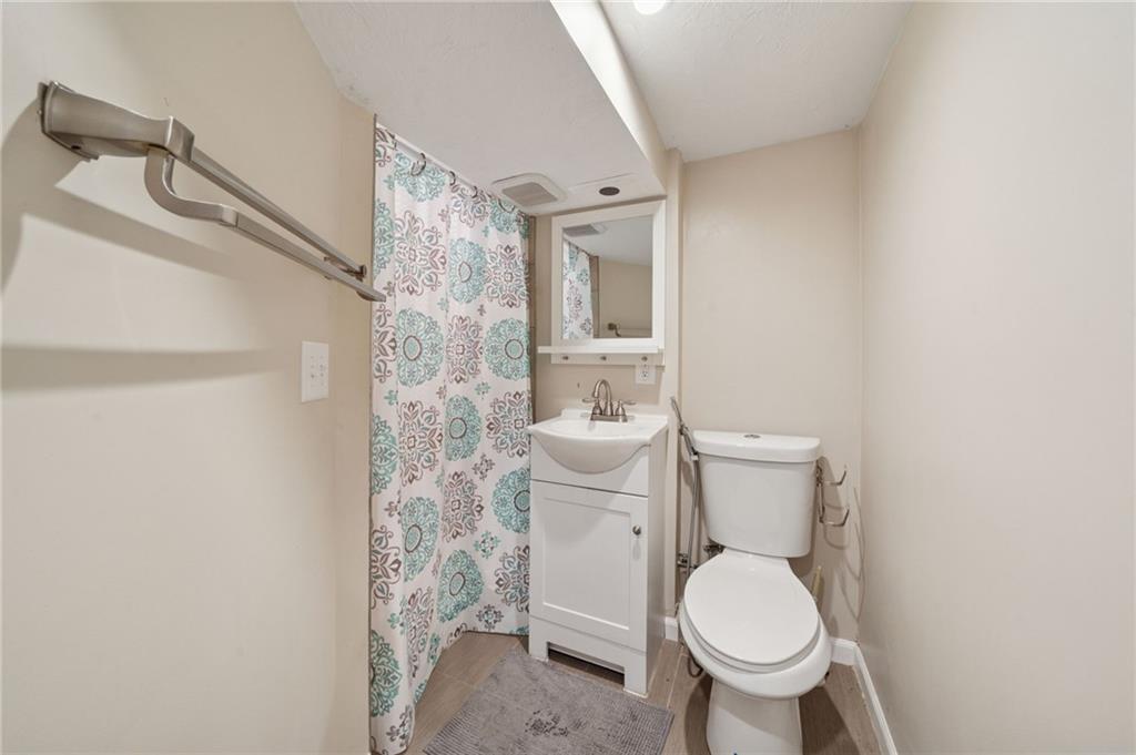 1202 Old Concord Road Monroeville, PA 15146 - Photo 22 of 27 a white toilet sitting next to a shower curtain
