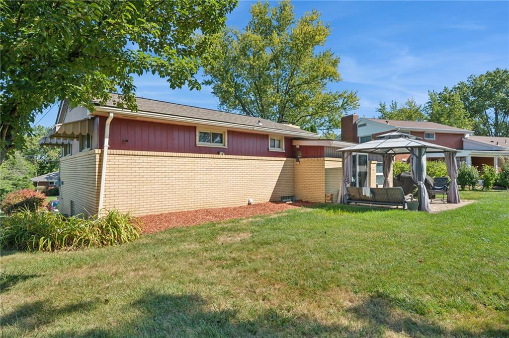 1202 Old Concord Road Monroeville, PA 15146 - Photo 26 of 27 a view of a yard in front of a house with plants and large tree