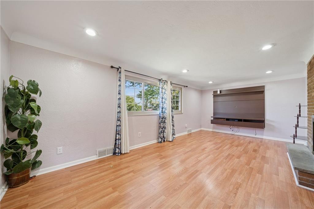1202 Old Concord Road Monroeville, PA 15146 - Photo 5 of 27 a view of an empty room with wooden floor and a window