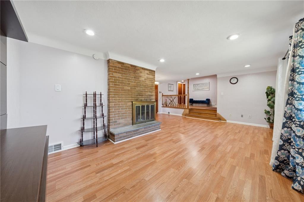 1202 Old Concord Road Monroeville, PA 15146 - Photo 6 of 27 a view of empty room with wooden floor and fireplace