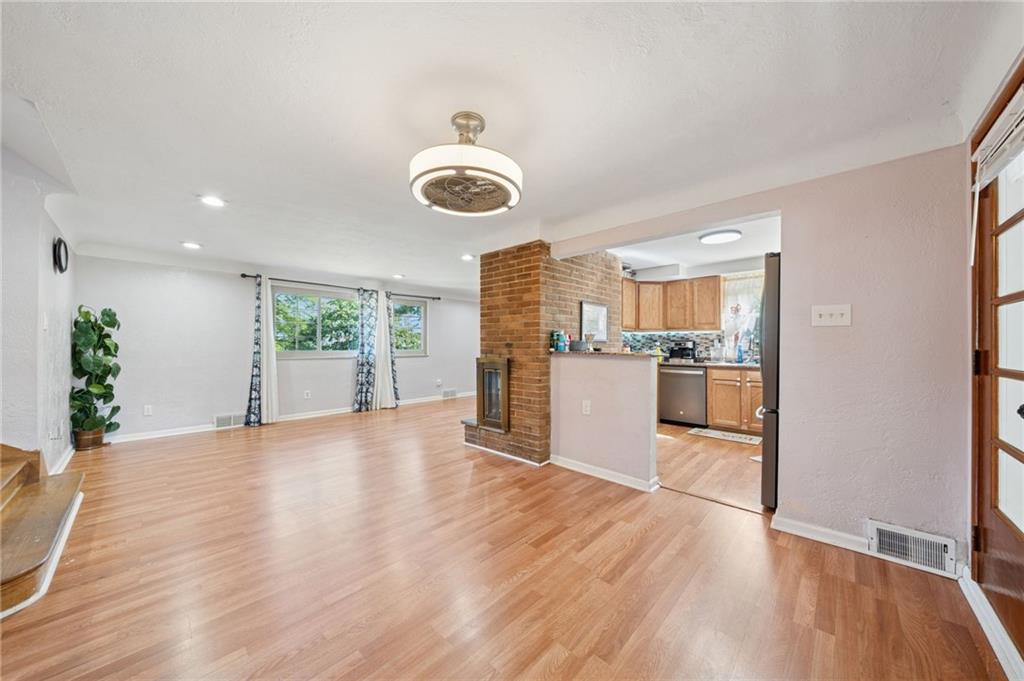 1202 Old Concord Road Monroeville, PA 15146 - Photo 8 of 27 a view of a big room with wooden floor and windows