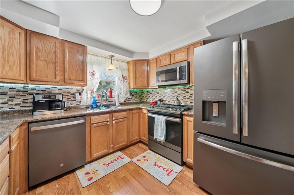 1202 Old Concord Road Monroeville, PA 15146 - Photo 9 of 27 a kitchen with stainless steel appliances granite countertop a refrigerator sink and stove