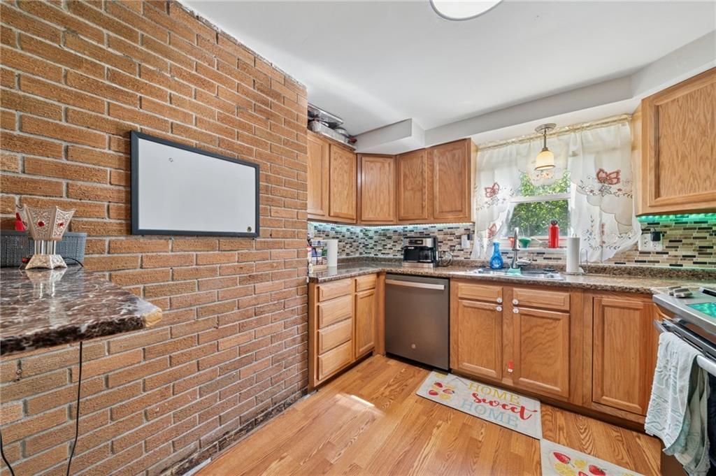 1202 Old Concord Road Monroeville, PA 15146 - Photo 10 of 27 a kitchen with granite countertop stainless steel appliances a stove sink and cabinets