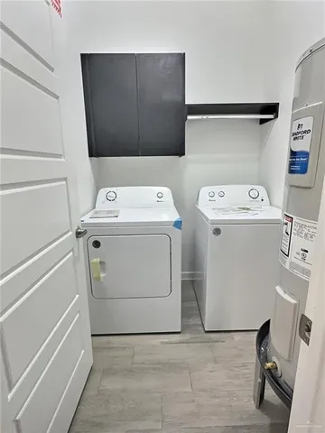 a bathroom with a granite countertop sink a toilet a mirror and bathtub