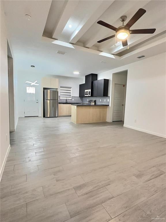 3912 Ventura Avenue, Unit 2 Edinburg, TX 78541 - Photo 11 of 12 a large kitchen with stainless steel appliances a large counter top a sink a window and a couch