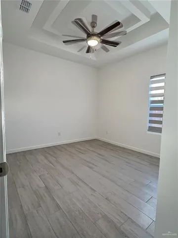 a view of a livingroom with a furniture cabinets and a ceiling fan
