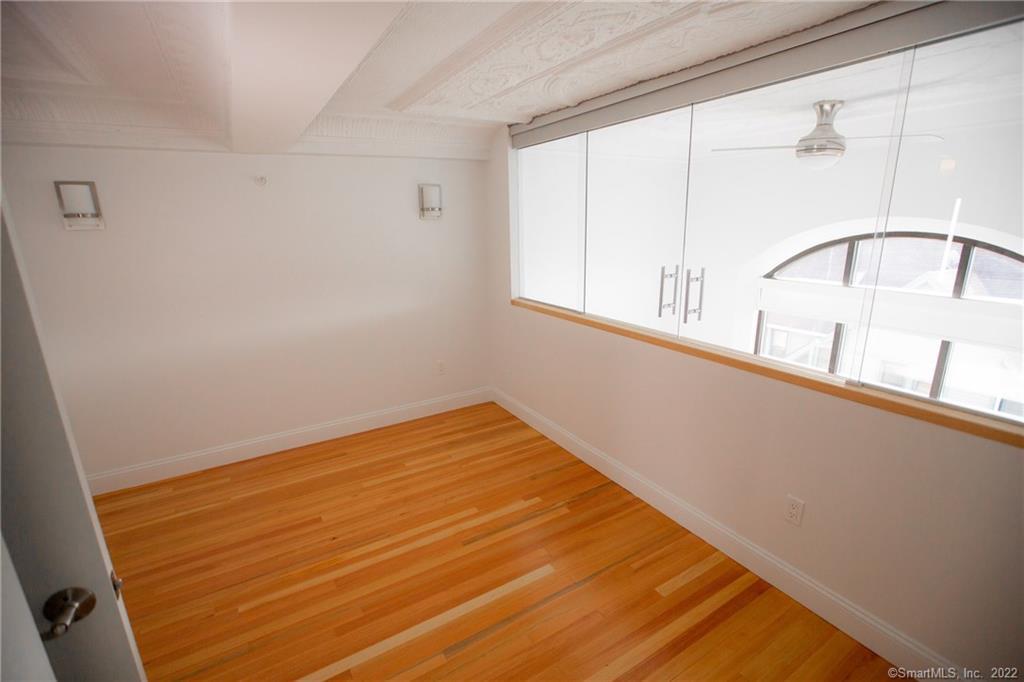 70 South Main Street, Unit 3B Norwalk, CT 06854 - Photo 11 of 21 a view of a room with wooden floor and white walls