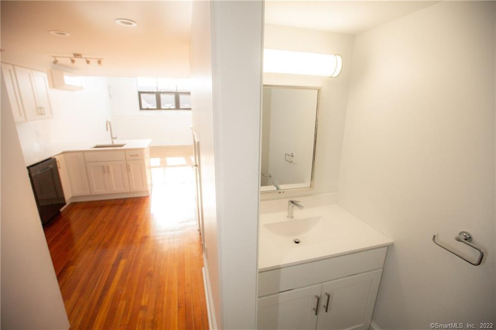 70 South Main Street, Unit 3B Norwalk, CT 06854 - Photo 4 of 21 a bathroom with a sink a toilet and mirror