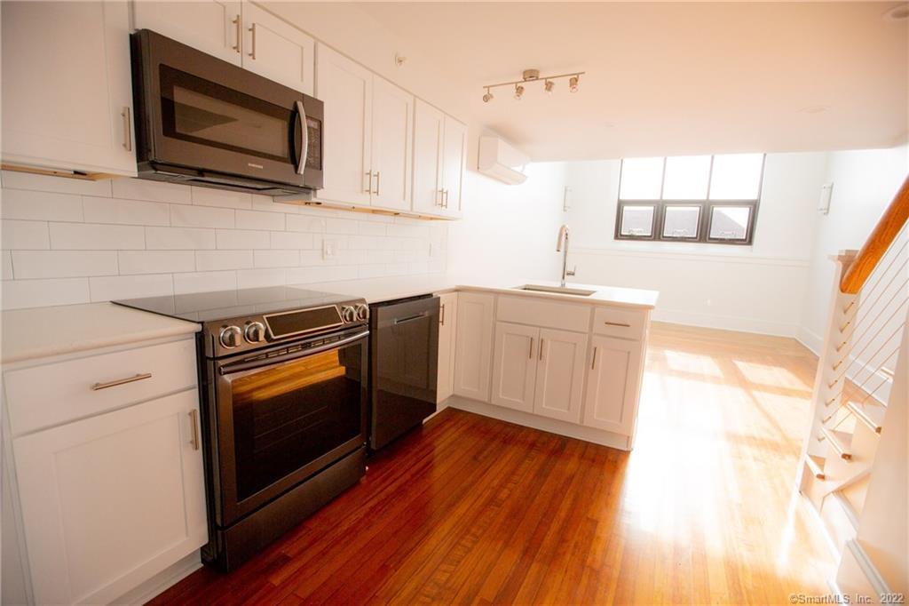 70 South Main Street, Unit 3B Norwalk, CT 06854 - Photo 6 of 21 a kitchen with stainless steel appliances a stove microwave and sink