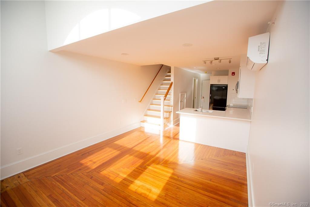 70 South Main Street, Unit 3B Norwalk, CT 06854 - Photo 7 of 21 a view of a hallway with wooden floor