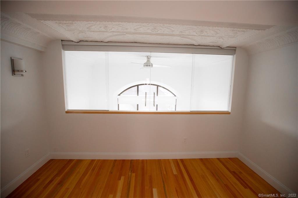 70 South Main Street, Unit 3B Norwalk, CT 06854 - Photo 10 of 21 a view of a small space with wooden floor and a window