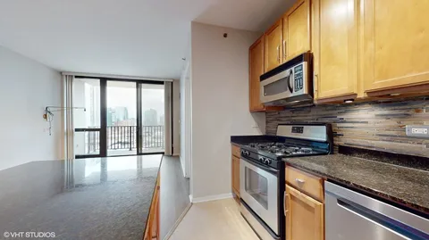 a kitchen with stainless steel appliances granite countertop a stove a sink and a microwave
