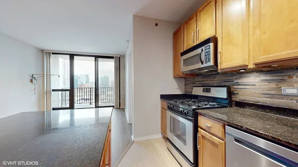 a kitchen with stainless steel appliances granite countertop a stove a sink and a microwave