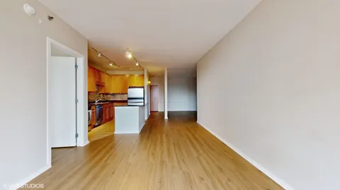 a view of a living room with wooden floor