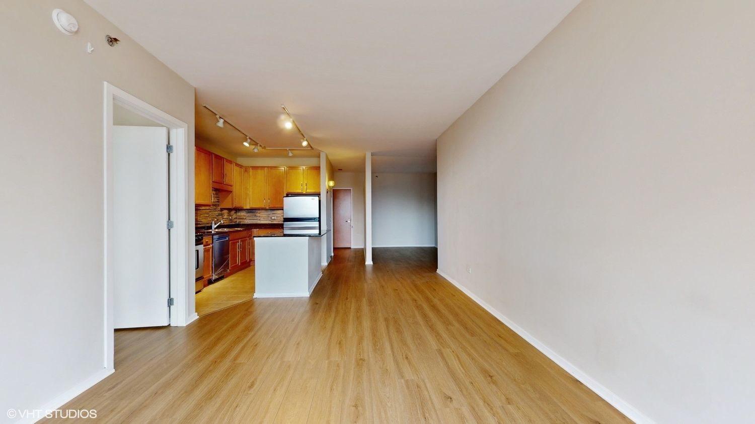 210 South Desplaines Street, Unit 907 Chicago, IL 60661 - Photo 5 of 17 a view of a living room with wooden floor