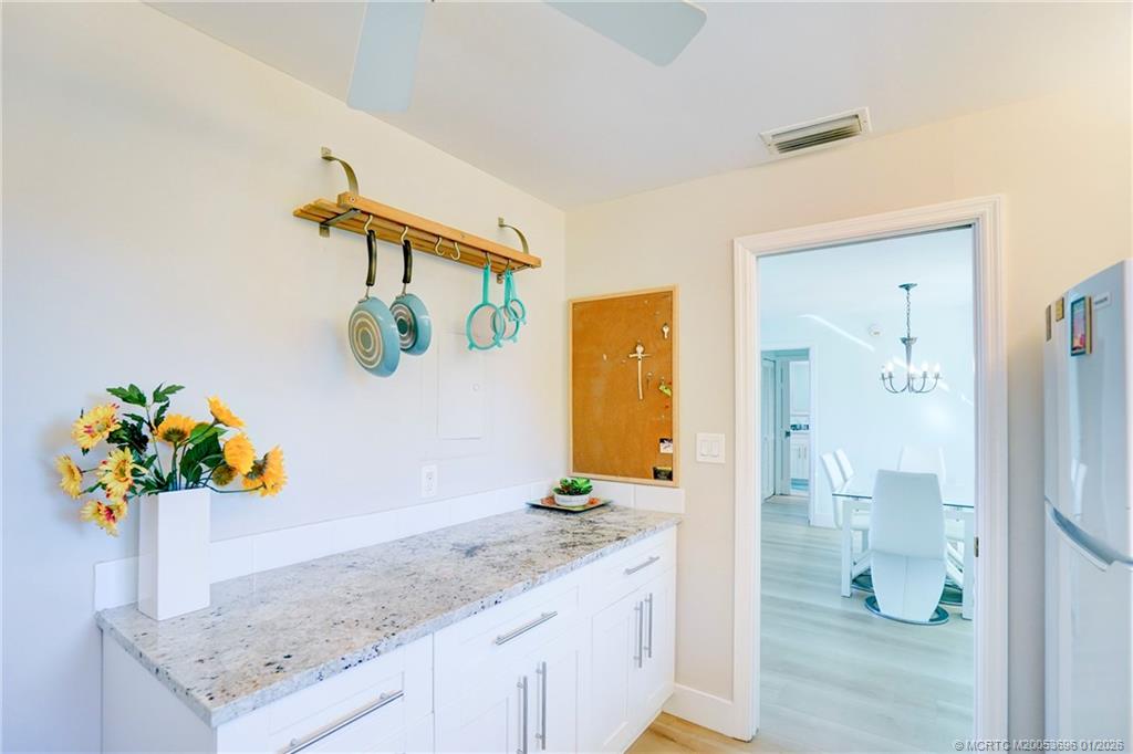 2370 Northeast Ocean Boulevard, Unit C205 Stuart, FL 34996 - Photo 14 of 80 a bathroom with a granite countertop sink a toilet and a mirror