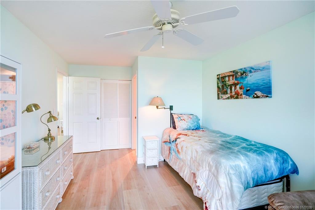 2370 Northeast Ocean Boulevard, Unit C205 Stuart, FL 34996 - Photo 15 of 80 a bedroom with a bed and a chandelier