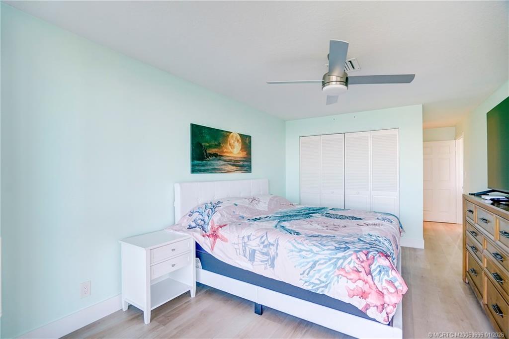 2370 Northeast Ocean Boulevard, Unit C205 Stuart, FL 34996 - Photo 19 of 80 a bedroom with a bed and a flat screen tv