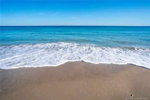 a bedroom with a bed and a flat tv screen on dresser
