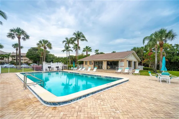 a view of outdoor space with chairs and swimming pool