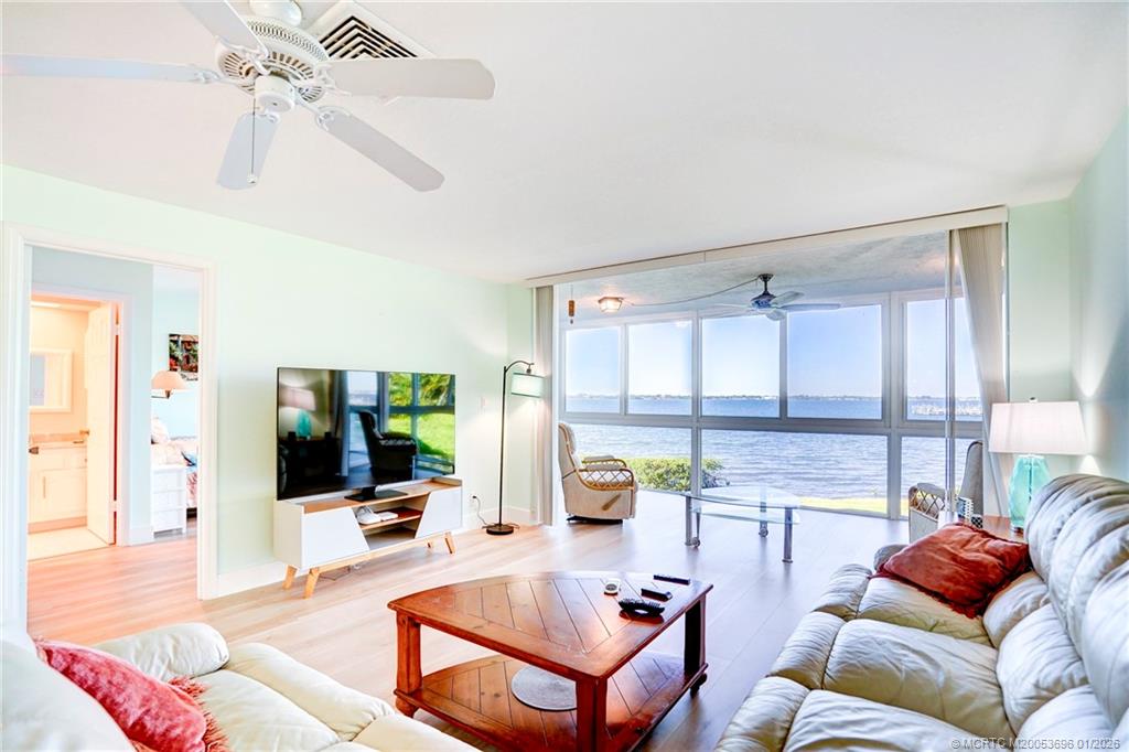 2370 Northeast Ocean Boulevard, Unit C205 Stuart, FL 34996 - Photo 39 of 80 a living room with furniture a flat screen tv and a large window