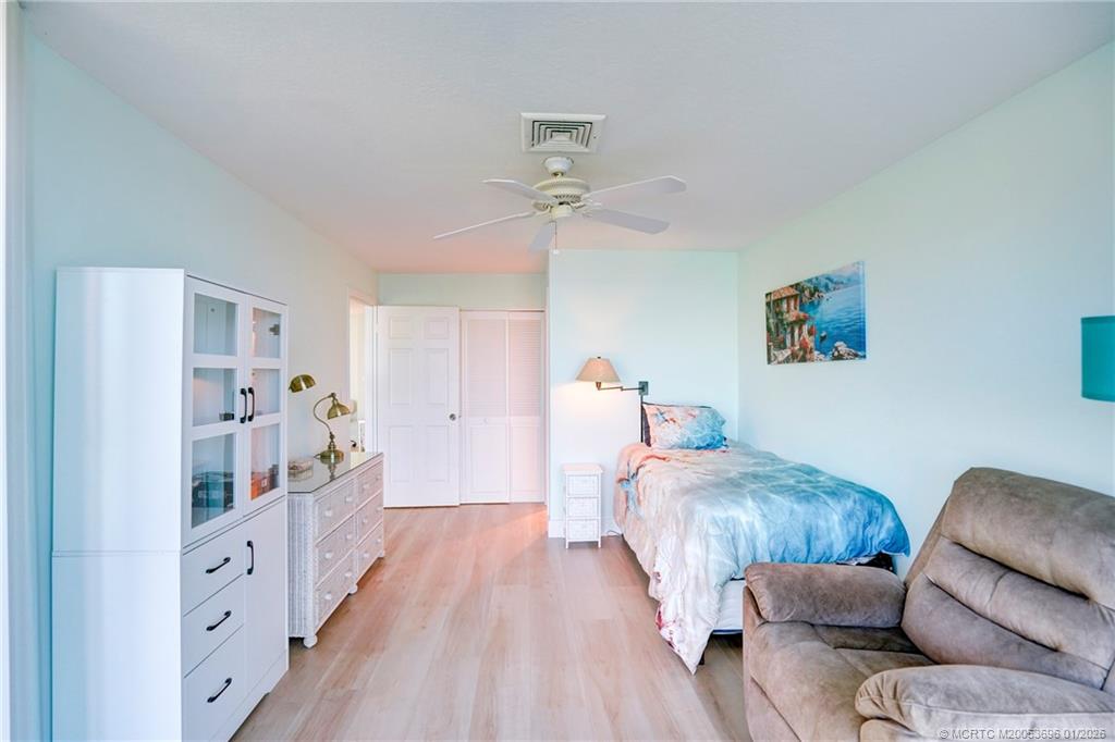 2370 Northeast Ocean Boulevard, Unit C205 Stuart, FL 34996 - Photo 50 of 80 a bed room with furniture and a chandelier