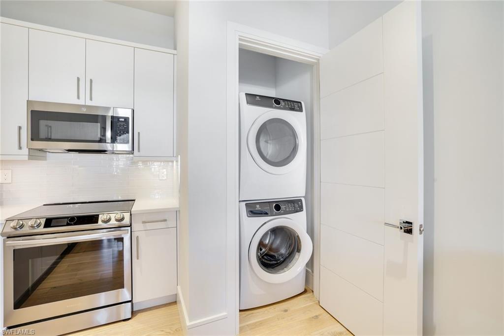 101 8th Street South, Unit 301 Naples, FL 34102 - Photo 7 of 17 a kitchen with a stove top oven and a microwave