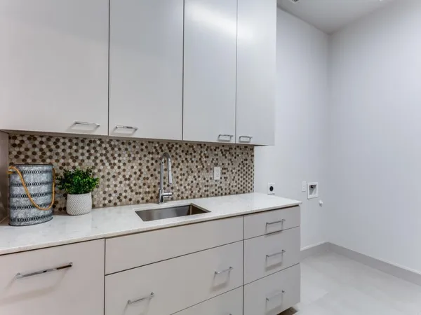 a kitchen with a sink and cabinets