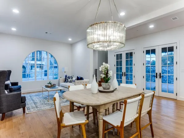 a view of a dining room with furniture wooden floor and chandelier