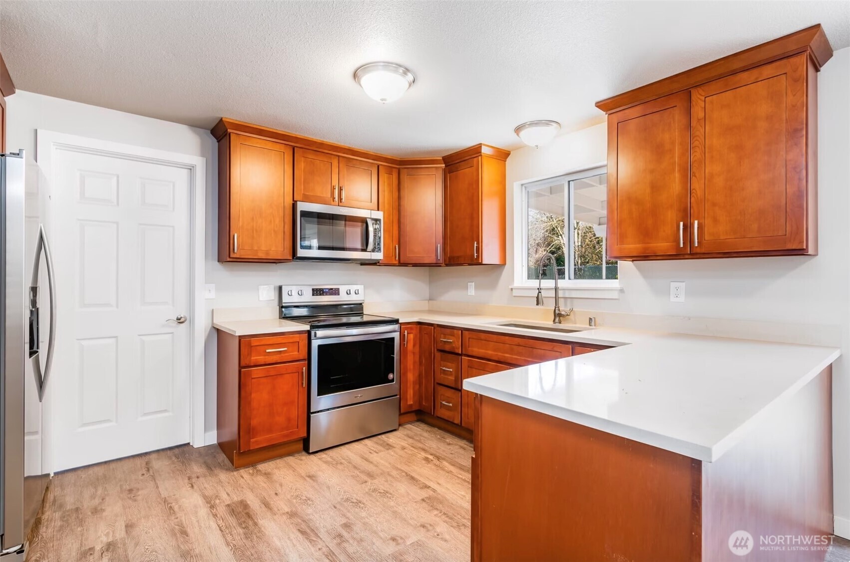 6235 A Street Tacoma, WA 98408 - Photo 6 of 12 a kitchen with stainless steel appliances granite countertop a sink stove and refrigerator