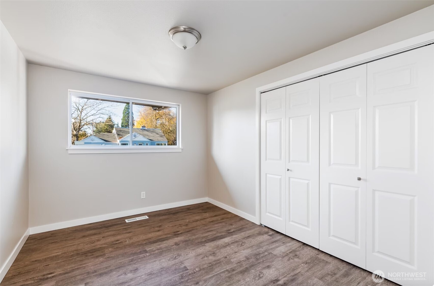 6235 A Street Tacoma, WA 98408 - Photo 9 of 12 a view of an empty room with wooden floor and window