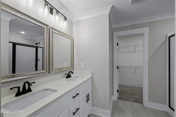 a bathroom with a double vanity sink and mirror