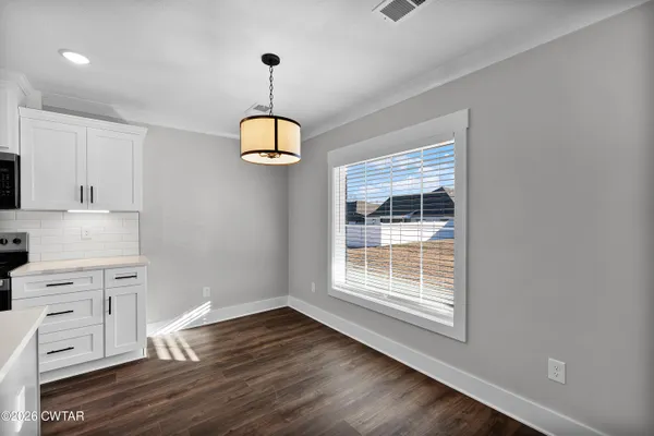 a kitchen with a sink stove top oven and cabinets