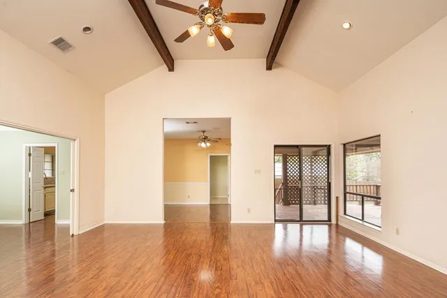 wooden floor in an empty room with a window