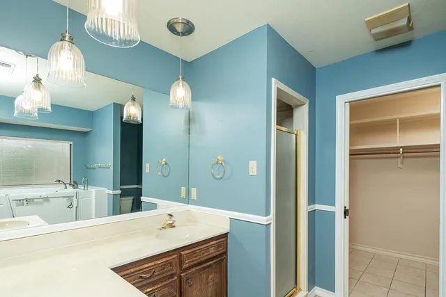 a bathroom with a sink tub and a mirror